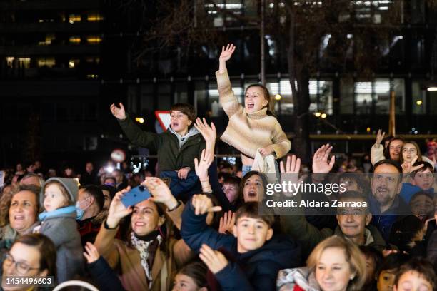 Children take candy during the Three Kings Parade in Madrid on January 05, 2023 in Madrid, Spain.