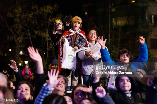 Children take candy during the Three Kings Parade in Madrid on January 05, 2023 in Madrid, Spain.