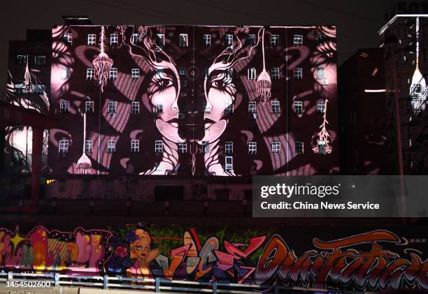 Colorful images are projected on buildings during a 3D mapping light show as part of the First Chongqing International Light Art Festival at...