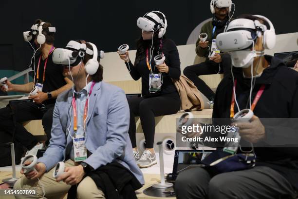 Attendees try out the Caliverse Hyper-Realistic Metaverse experience at the Lotte booth at CES 2023 at the Las Vegas Convention Center on January 05,...