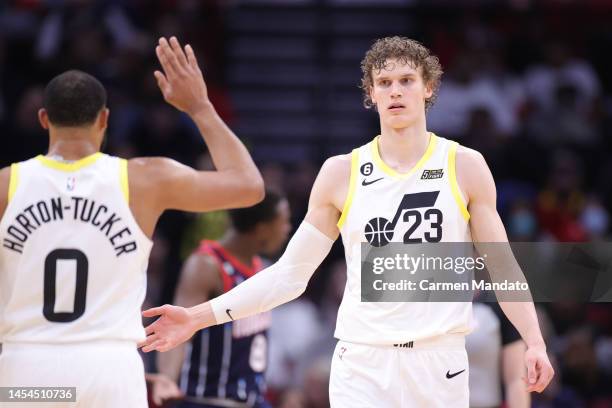 Lauri Markkanen high fives Talen Horton-Tucker of the Utah Jazz against the Houston Rockets during the second half at Toyota Center on January 05,...