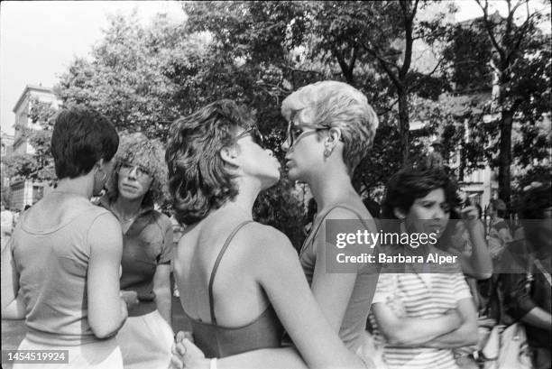 Two women embrace and kiss during the in the Lesbian and Gay Pride March , New York, New York, June 26, 1983.