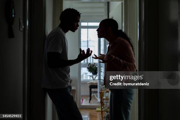 stressed couple arguing, blaming each other - partner violence stock pictures, royalty-free photos & images