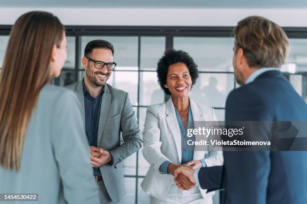 successful partnership - black business woman shaking hands stock pictures, royalty-free photos & images