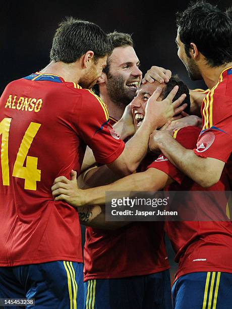 Santi Cazorla of Spain celebrates scoring from a free kick with teammates Xabi Alonso and Juan Mata during the international friendly match between...