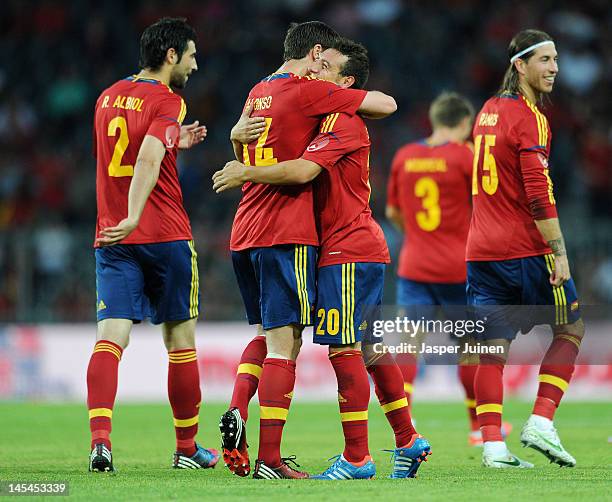 Santi Cazorla of Spain celebrates scoring from a free kick with teammate Xabi Alonso as Sergio Ramos and Raul Albiol look on during the international...