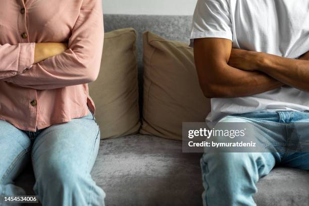 couple having a disagreement at home - vechten stockfoto's en -beelden