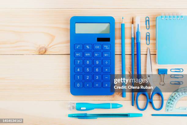 blue notebook and office supplies - staples office stockfoto's en -beelden