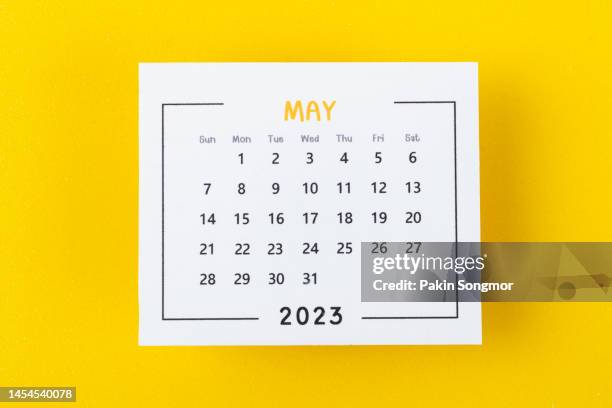 calendar desk 2023: may is the month for the organizer to plan and deadline with a yellow paper background. - maio imagens e fotografias de stock