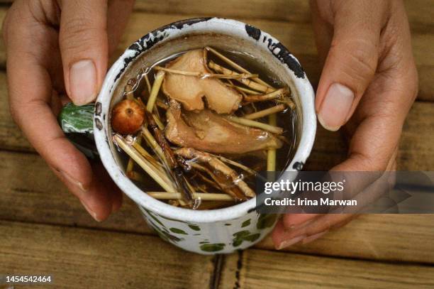 drinking traditional herbal drink - ginger tea stock pictures, royalty-free photos & images