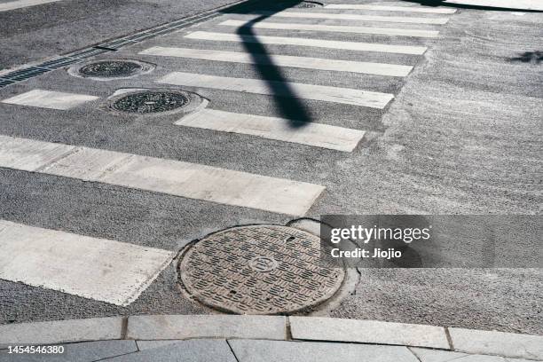 zebra crossing - manhole stock pictures, royalty-free photos & images