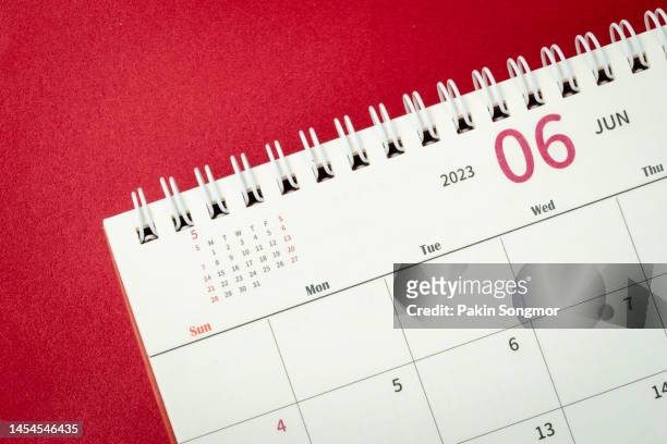 calendar desk 2023: june is the month for the organizer to plan and deadline with a red paper background. - desk calendar stock pictures, royalty-free photos & images