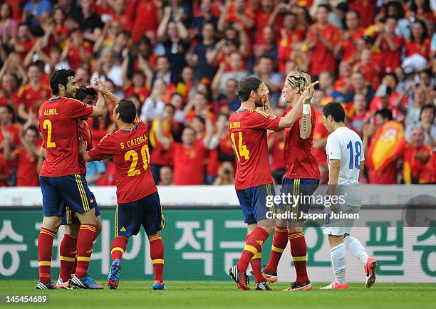 Fernando Torres of Spain celebrates scoring with his teammate Xabi Alonso and Santi Cazorla , Benat Etxebarria and Raul Albiol as Tae Hee Nam of...