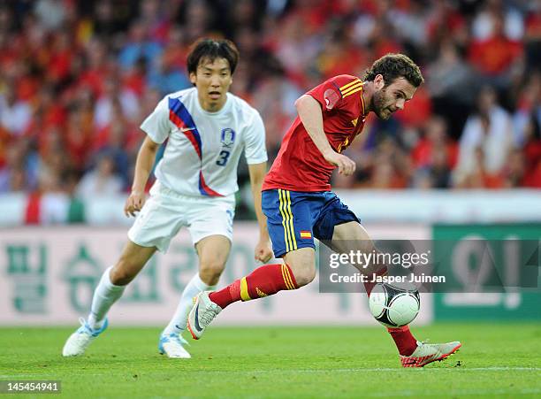 Juan Mata of Spain controls the ball besides Yong Hyung Cho of Korea Republic during the international friendly match between Spain and Korea...