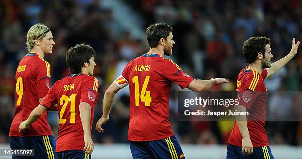 Xabi Alonso of Spain celebrates scoring from the penalty spot with his teammates Juan Mata , David Silva and Fernando Torres during the international...
