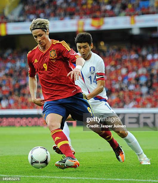 Fernando Torres of Spain shields Jung Soo Lee of Korea Republic from the ball during the international friendly match between Spain and Korea...