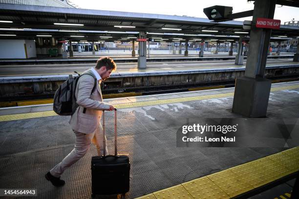 Man walks towards a train at Waterloo station as disruption to services begins during the morning rush hour, due to ongoing strike action on January...