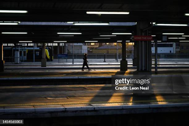 Woman walks along an empty train platform at Waterloo station as disruption to services is seen during the morning rush hour, due to ongoing strike...