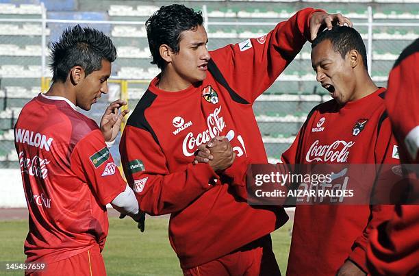 Bolivian national football team players Ruddy Cardozo , Gabriel Valverde and Edemir Rodriguez, joke during a training session in La Paz, on 30 May,...