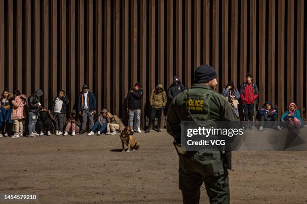 Immigrants wait to be processed by the U.S. Border Patrol after crossing the border from Mexico on December 30, 2022 in Yuma, Arizona.