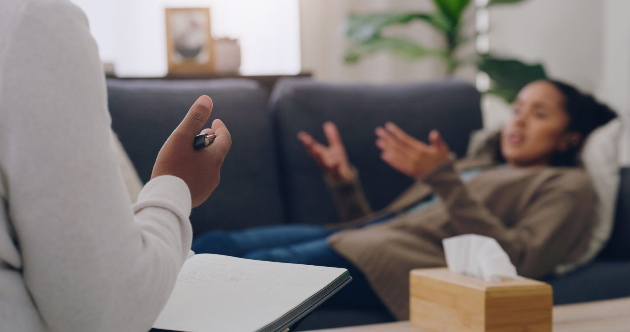 Mental health, patient and therapist have discussion, for depression and talking anger management. Psychologist with book, female client on couch or conversation for anxiety, healthcare or consulting Mental health, patient and therapist have discussion, for depression and talking anger management. Psychologist with book, female client on couch or conversation for anxiety, healthcare or consulting