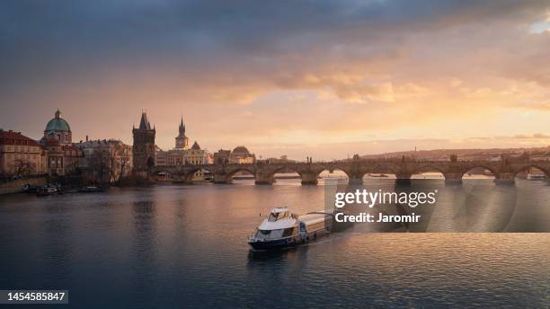 charles bridge over the vltava river at sunset - prague river stock pictures, royalty-free photos & images