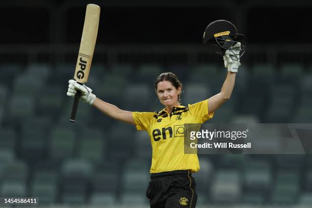 Maddy Darke of Western Australia raises her bat after scoring one hundred runs during the WNCL match between Western Australia and South Australia at...