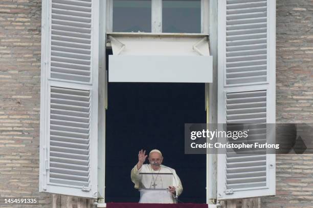 Pope Francis delivers his Angelus blessing from the window of his private studio to pilgrims gathered in Saint Peter's Square during the Feast of the...