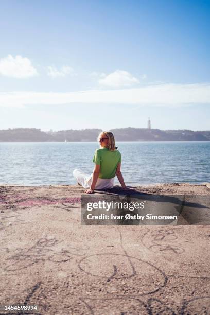 millennial woman enjoying the view - waterfront stock pictures, royalty-free photos & images