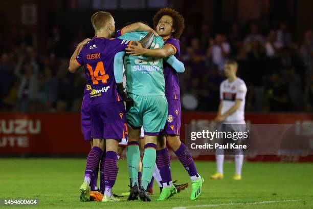 Jack Clisby and Mustafa Amini of the Glory celebrate with Cameron Cook after winning the round 11 A-League Men's match between Perth Glory and...