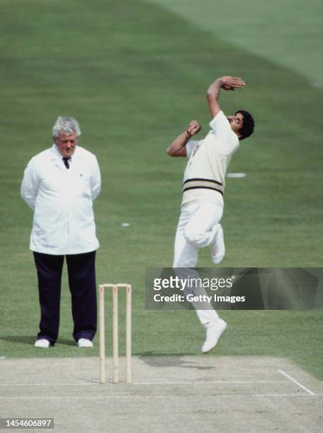India captain Kapil Dev in bowling action watched by umpire David Shepherd during the 1983 Cricket World Cup against West Indies at the Oval on June...