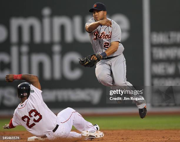 Miguel Cabrera of the Detroit Tigers turns a double play as Marlon Byrd of the Boston Red Sox slides in the third inning at Fenway Park May 30, 2012...