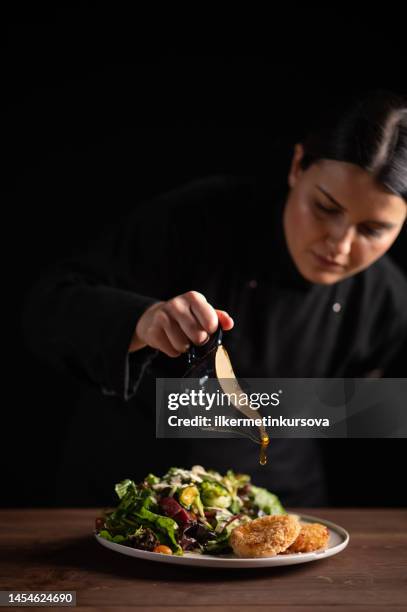 a female chef in restaurant decorating a plate of salad - serving dish stock pictures, royalty-free photos & images