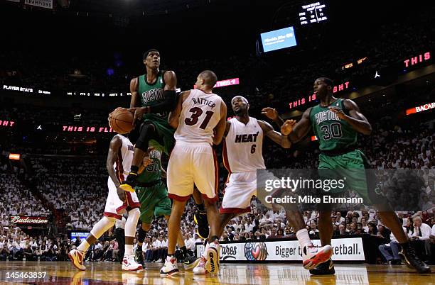 Rajon Rondo of the Boston Celtics drives for a shot attempt in the first half against Shane Battier and LeBron James of the Miami Heat in Game Two of...