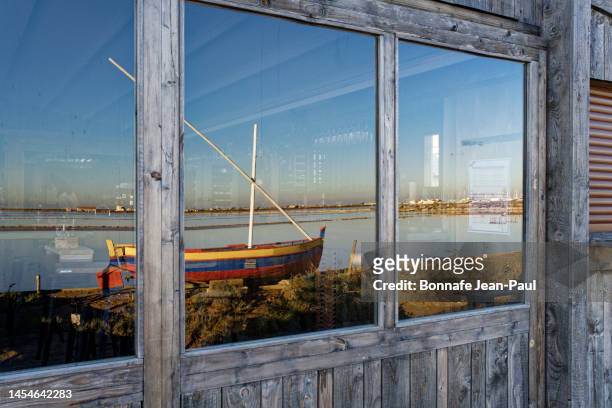 reflection of the boat in the window of the restaurant - aude stock pictures, royalty-free photos & images