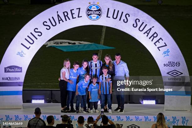 Luis Suarez and his wife Sofia Balbi poses for photos at main stage with family during his presentation at Arena do Gremio on January 4, 2023 in...
