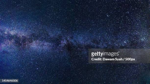 low angle view of stars in sky at night,indonesia - universo foto e immagini stock