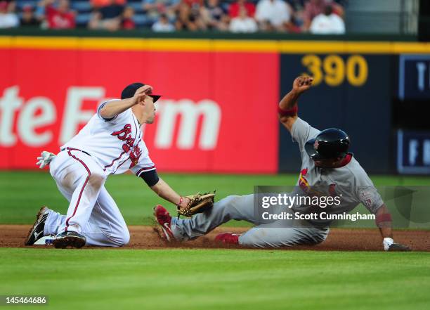 Rafael Furcal of the St. Louis Cardinals slides safely in to second base as the ball was dropped by Jack Wilson of the Atlanta Braves at Turner Field...