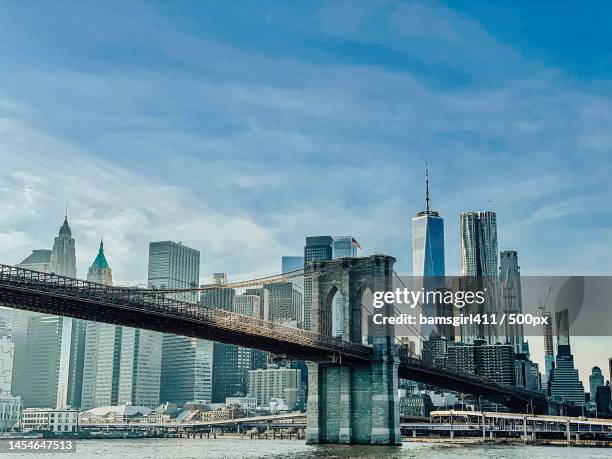 view of skyscrapers against cloudy sky,new york,united states,usa - new york city skyline fotografías e imágenes de stock