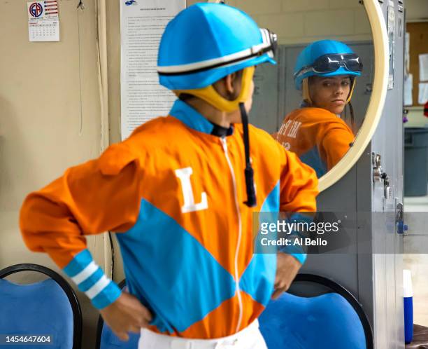 Student Jockey Bryan Torres looks at himself in the mirror in preparation for his race at the Vocational Equestrian Agustín Mercado Reverón School...