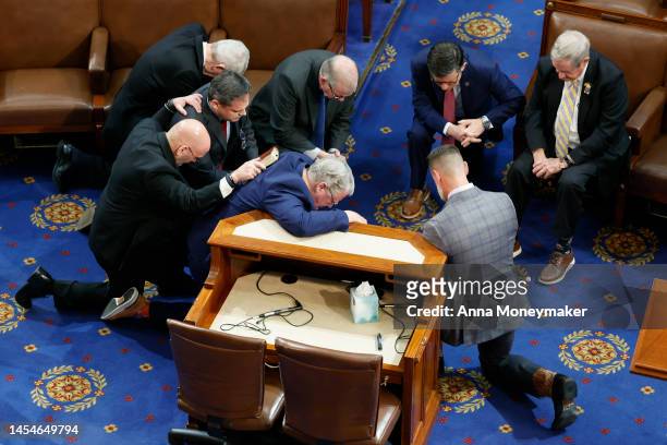 Members-elect pray together in the House Chamber during the fourth day of elections for Speaker of the House at the U.S. Capitol Building on January...