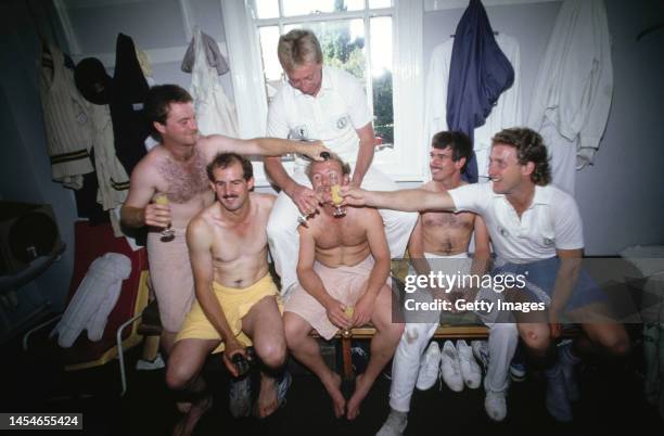 Notts players including Chris Broad and Bruce French celebrate in the dressing room after Notts had beaten Glamorgan to win the 1987 County Cricket...