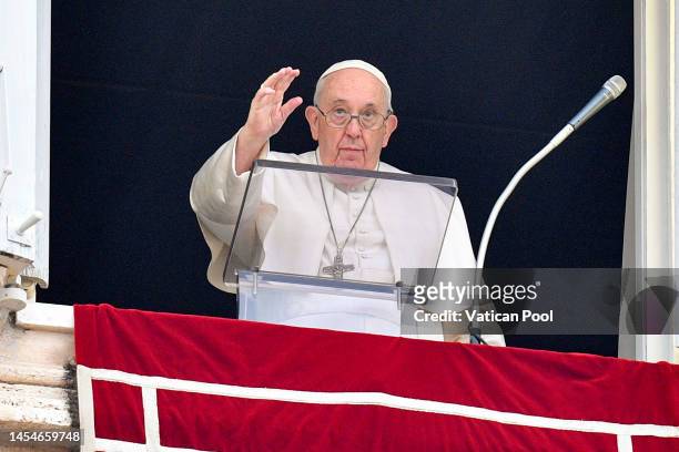 Pope Francis delivers his Angelus blessing from the window of his private studio to pilgrims gathered in Saint Peter's Square during the Feast of the...