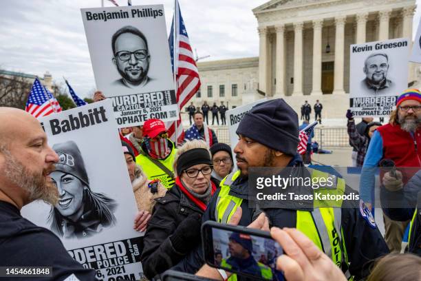 Capitol police stand guard among supporters of protesters that were arrested on Jan 6, 2021 as they protest outside the U.S. Supreme Court on the...