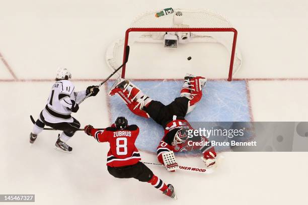 Anze Kopitar of the Los Angeles Kings shoots the game winning goal in overtime against Dainius Zubrus and Martin Brodeur of the New Jersey Devils...