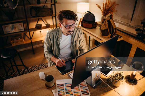 graphic designer works in his office - graphic designer stock pictures, royalty-free photos & images
