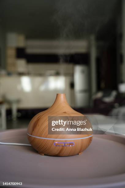 aromatherapy diffuser at home on table, air humidifier. gentle mist with essential oils. - mist diffuser stock pictures, royalty-free photos & images
