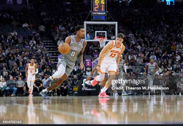 Malik Monk of the Sacramento Kings drives to the basket past Bogdan Bogdanovic of the Atlanta Hawks during the first quarter of an NBA basketball...