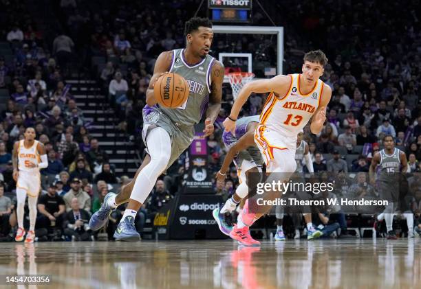 Malik Monk of the Sacramento Kings drives to the basket past Bogdan Bogdanovic of the Atlanta Hawks during the first quarter of an NBA basketball...
