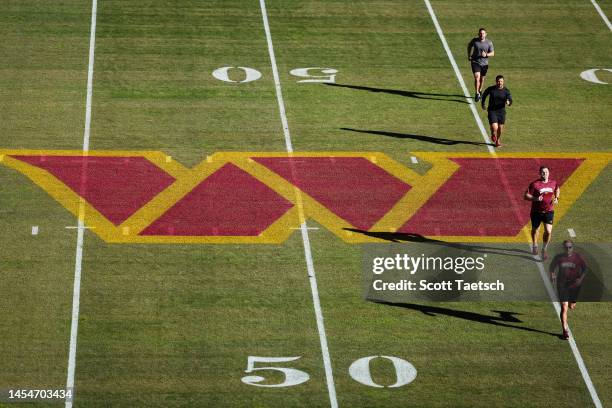 General view of the Washington Commanders logo on the field as staff members warmup before the game between the Washington Commanders and the...